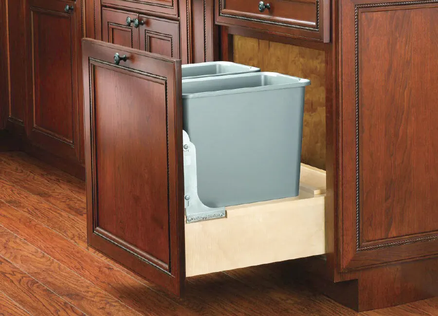 Double waste can pullout in a cherry base cabinet